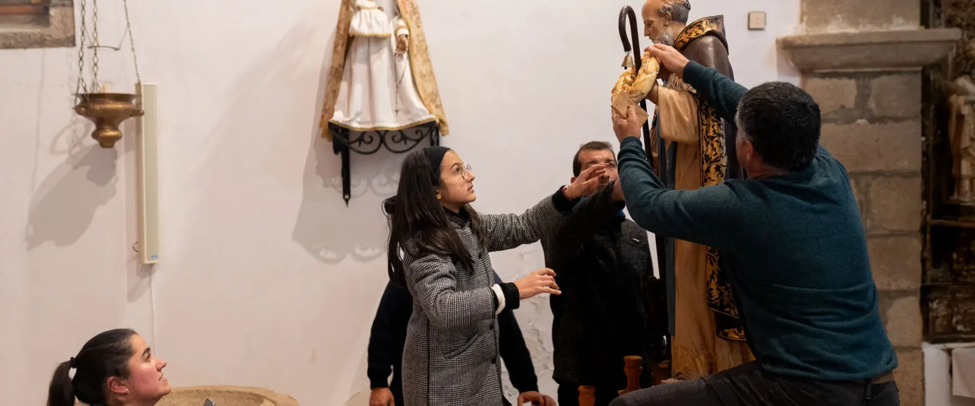 Una niña ayuda a colocar la rosca a San Antonio. Foto Emilio Fraile.